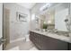 Double vanity bathroom with granite countertop and glass shower at 1529 Corolla Ct, Reunion, FL 34747