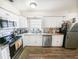Bright kitchen featuring white cabinets, granite countertops, and stainless steel appliances at 3053 George Mason Ave # D, Winter Park, FL 32792