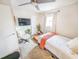 Well-lit bedroom featuring a comfortable bed, a home office setup, and a ceiling fan at 3053 George Mason Ave # D, Winter Park, FL 32792