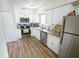 Modern kitchen with white cabinets, granite countertops, and stainless steel appliances at 3053 George Mason Ave # D, Winter Park, FL 32792