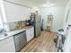 Updated kitchen with white cabinets, granite countertops, and stainless steel appliances at 3053 George Mason Ave # D, Winter Park, FL 32792