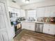 Clean and efficient kitchen with white cabinets and granite countertops at 3053 George Mason Ave # D, Winter Park, FL 32792