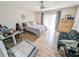 Bright bedroom with a comfortable bed, an office space, and a view to a private balcony at 3053 George Mason Ave # D, Winter Park, FL 32792
