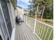 Private balcony with composite decking and seating, overlooking a green space at 3053 George Mason Ave # D, Winter Park, FL 32792