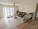 Living room with a leather couch, a chair, and wood-look flooring at 3053 George Mason Ave # D, Winter Park, FL 32792