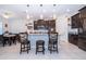 Modern kitchen with island and breakfast bar seating at 3140 Agostino Ter, Kissimmee, FL 34746