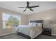 Spacious bedroom with large window and ceiling fan at 8962 Cuban Palm Rd, Kissimmee, FL 34747