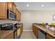 Modern kitchen with stainless steel appliances and granite countertops at 8962 Cuban Palm Rd, Kissimmee, FL 34747