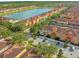 Aerial view of a vibrant community with lakefront homes and lush landscaping at 8962 Cuban Palm Rd, Kissimmee, FL 34747