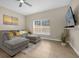 Spacious living room with comfortable sectional sofa and large window at 8962 Cuban Palm Rd, Kissimmee, FL 34747