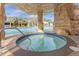 Relaxing hot tub nestled under a rock grotto, near the community pool at 8962 Cuban Palm Rd, Kissimmee, FL 34747