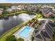 Community pool, lake, and clubhouse view at 14304 Fredricksburg Dr # 420, Orlando, FL 32837