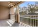Screened balcony with ceiling fan and view of trees at 14304 Fredricksburg Dr # 420, Orlando, FL 32837