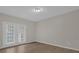 Bright bedroom with wood-look floors and access to patio at 14304 Fredricksburg Dr # 420, Orlando, FL 32837