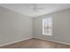 Bright bedroom with wood-look floors and ceiling fan at 14304 Fredricksburg Dr # 420, Orlando, FL 32837