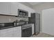 Modern kitchen with stainless steel appliances and white cabinets at 14304 Fredricksburg Dr # 420, Orlando, FL 32837