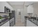 Modern kitchen with stainless steel appliances and white cabinets at 14304 Fredricksburg Dr # 420, Orlando, FL 32837