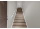 Indoor view of wooden staircase with simple railing at 14304 Fredricksburg Dr # 420, Orlando, FL 32837
