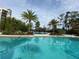Resort-style pool with palm trees and building view at 14501 Grove Resort Ave # 1332, Winter Garden, FL 34787