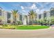 Luxury building with palm trees and a fountain at 14501 Grove Resort Ave # 1332, Winter Garden, FL 34787