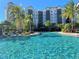 Resort-style pool with palm trees and building view at 14501 Grove Resort Ave # 1332, Winter Garden, FL 34787
