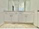 Double vanity bathroom with white cabinets and a large mirror at 1652 Cross Prairie Pkwy, Kissimmee, FL 34744