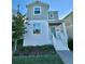 Two-story home with light grey siding and green door at 1652 Cross Prairie Pkwy, Kissimmee, FL 34744