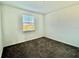 Bright bedroom with neutral carpeting and window at 1652 Cross Prairie Pkwy, Kissimmee, FL 34744