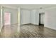 Large living area with wood-look floors and access to other rooms at 1652 Cross Prairie Pkwy, Kissimmee, FL 34744