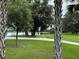 Scenic community park with a pond, lush landscaping, and a park bench at 1652 Cross Prairie Pkwy, Kissimmee, FL 34744