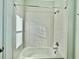 White tiled bathroom with a shower/tub combo and window at 1652 Cross Prairie Pkwy, Kissimmee, FL 34744