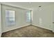 Bright bedroom featuring neutral walls and carpet, plus two windows at 1652 Cross Prairie Pkwy, Kissimmee, FL 34744