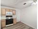 Bright kitchen features wood cabinets, gas range, microwave, and vinyl flooring at 2788 Privada Dr, The Villages, FL 32162