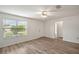 Living room with wood-look floors, window, and ceiling fan at 2788 Privada Dr, The Villages, FL 32162