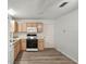 Bright kitchen features wood cabinets, gas range, microwave, and vinyl flooring at 2788 Privada Dr, The Villages, FL 32162