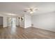 Bright living room with light wood floors and ceiling fan at 2788 Privada Dr, The Villages, FL 32162