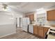 Kitchen with wood cabinets, dishwasher, and vinyl flooring at 2788 Privada Dr, The Villages, FL 32162