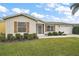 Front view of a beige house with landscaping at 2788 Privada Dr, The Villages, FL 32162
