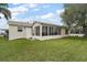 Exterior view of a house with a sunroom and yard at 2788 Privada Dr, The Villages, FL 32162