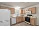 Kitchen with wood cabinets, dishwasher, and vinyl flooring at 2788 Privada Dr, The Villages, FL 32162