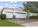 One story house with a three car garage and brick driveway at 2871 Sandy Cay St, Clermont, FL 34711