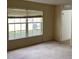 Spacious bedroom with large window and neutral carpeting at 3001 Mandolin Dr, Kissimmee, FL 34744