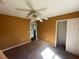 Carpeted bedroom with ceiling fan and double-door closet at 3001 Mandolin Dr, Kissimmee, FL 34744
