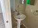 Simple bathroom with pedestal sink and mirror at 3001 Mandolin Dr, Kissimmee, FL 34744