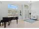 Bright entryway with grand piano, tiled floor, and French doors at 9810 Camberley Cir, Orlando, FL 32836