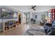 Relaxing living area with sectional sofa, large TV, and hardwood floors at 9810 Camberley Cir, Orlando, FL 32836