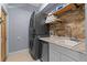 Modern laundry room with stacked washer and dryer, plus a utility sink at 9810 Camberley Cir, Orlando, FL 32836