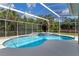 Inviting screened-in pool with a spa and ample deck space at 9810 Camberley Cir, Orlando, FL 32836