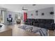 Spacious living area with sectional sofa, hardwood floors, and a home office area at 9810 Camberley Cir, Orlando, FL 32836