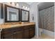 Bathroom with dual vanity, granite countertop, and shower/tub combo at 9810 Camberley Cir, Orlando, FL 32836